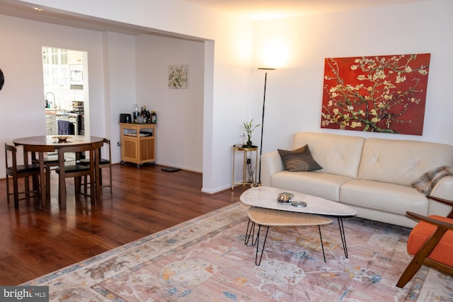 living room featuring baseboards and wood finished floors