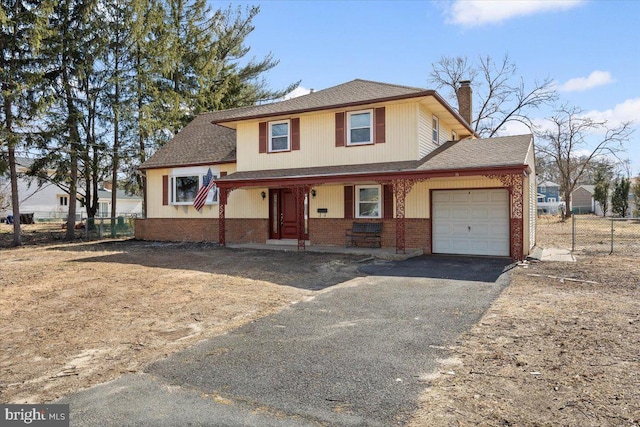 view of front of house with fence, an attached garage, a chimney, aphalt driveway, and brick siding