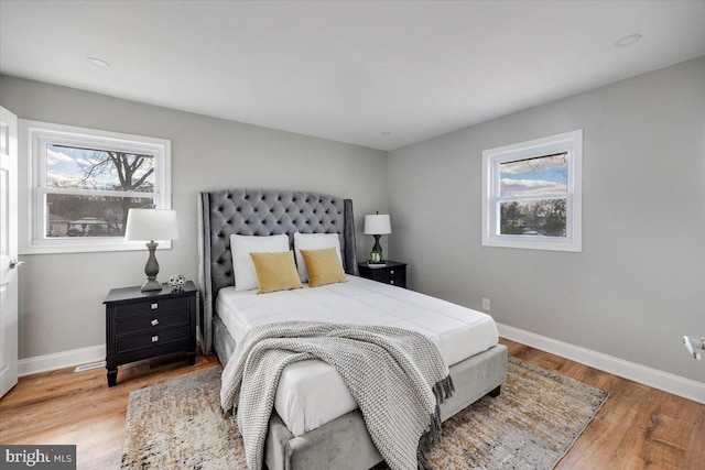 bedroom with light wood-style flooring and baseboards