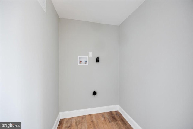 washroom featuring wood finished floors, baseboards, hookup for an electric dryer, hookup for a washing machine, and laundry area