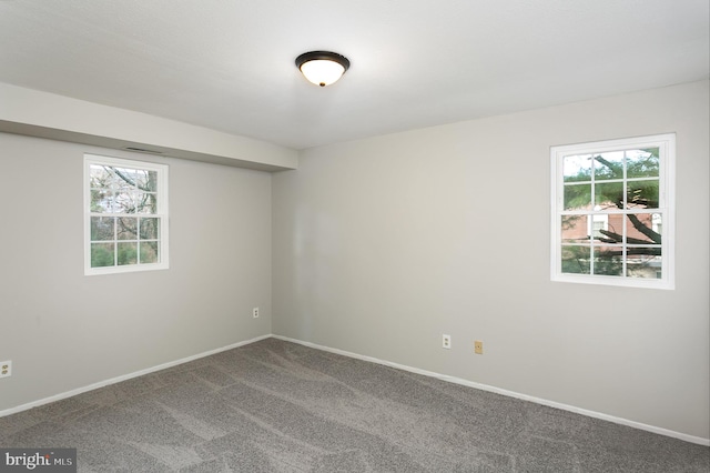 unfurnished room with baseboards and carpet flooring