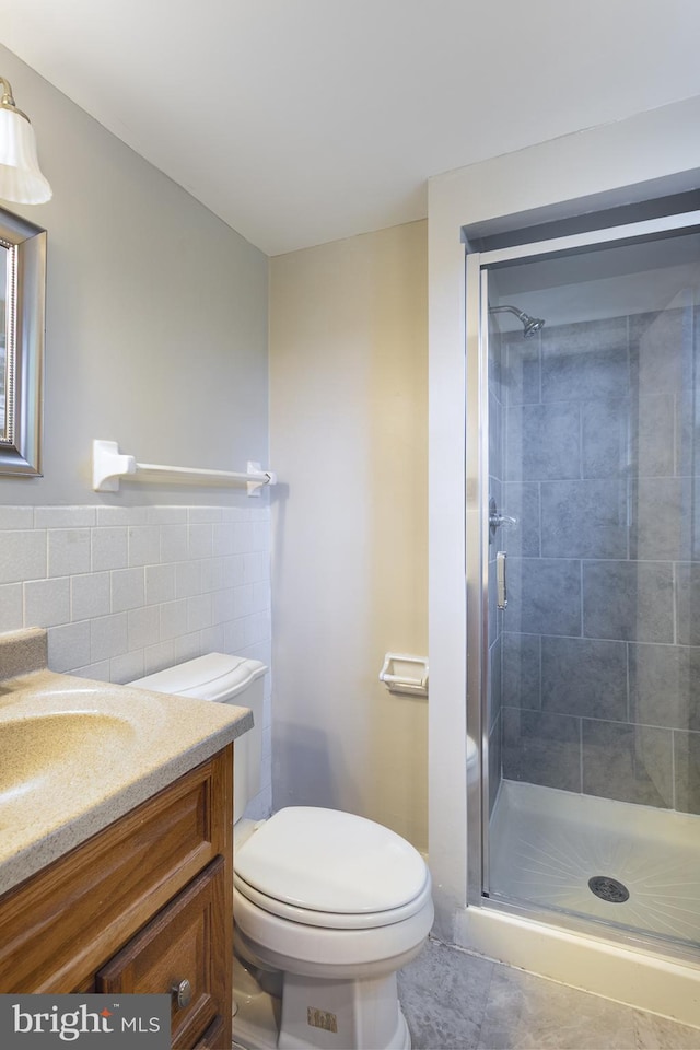 bathroom with vanity, toilet, and a shower stall