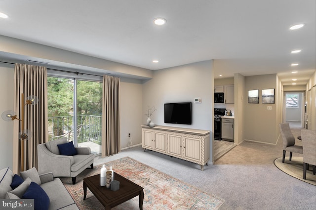 living room featuring light carpet, recessed lighting, and baseboards