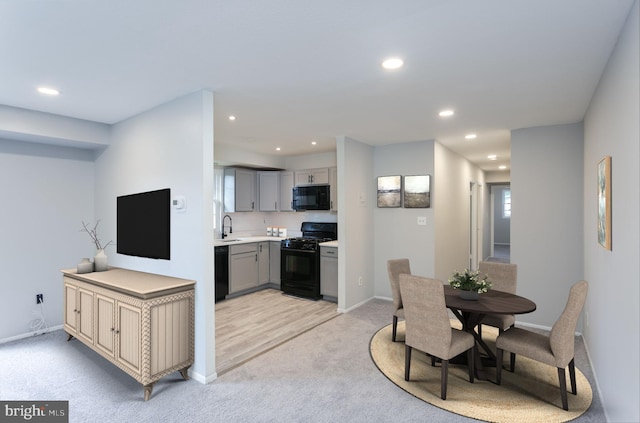 interior space featuring recessed lighting, light colored carpet, and baseboards