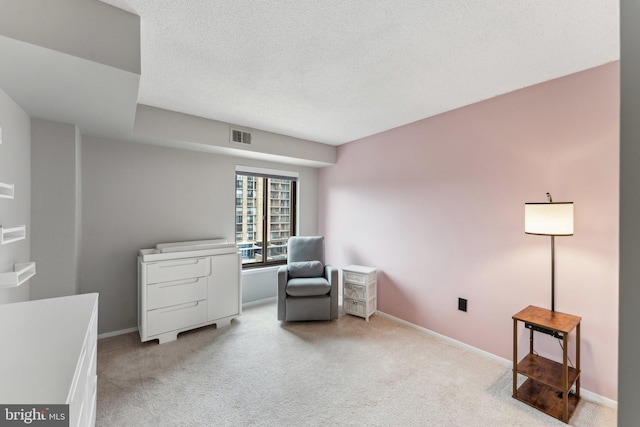 living area featuring visible vents, light carpet, and baseboards