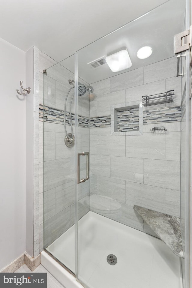 full bath featuring a shower stall and visible vents