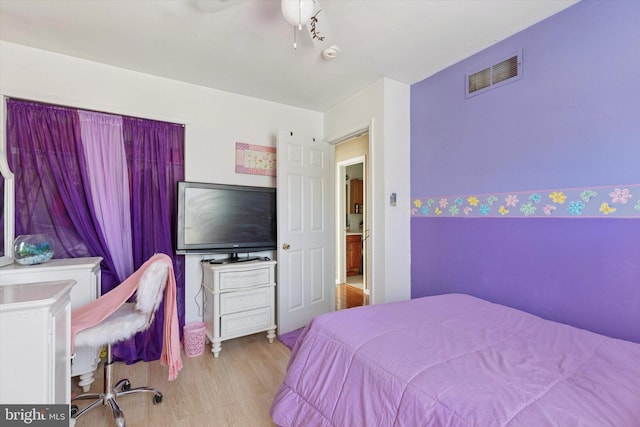 bedroom featuring visible vents and wood finished floors