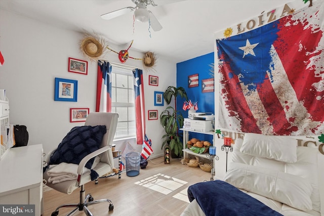 interior space with a ceiling fan and wood finished floors