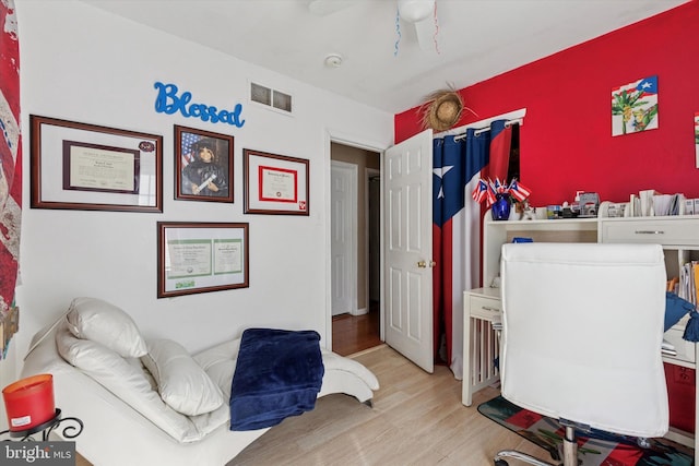 bedroom with visible vents and wood finished floors