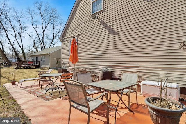 view of patio featuring a wooden deck and outdoor dining space