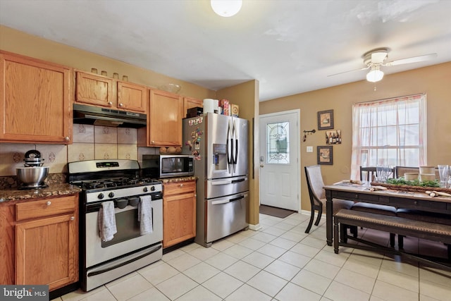 kitchen featuring under cabinet range hood, appliances with stainless steel finishes, light tile patterned flooring, and a ceiling fan