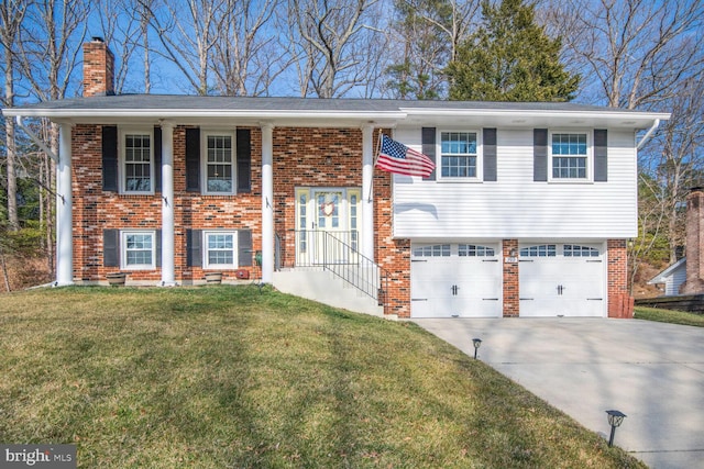 raised ranch with brick siding, concrete driveway, a front yard, a chimney, and an attached garage