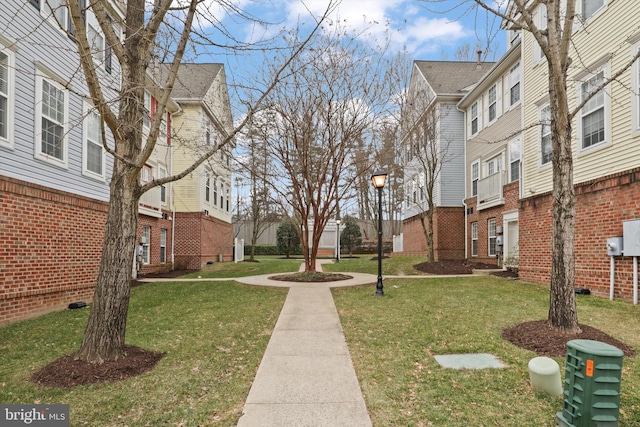 view of community featuring a residential view and a yard