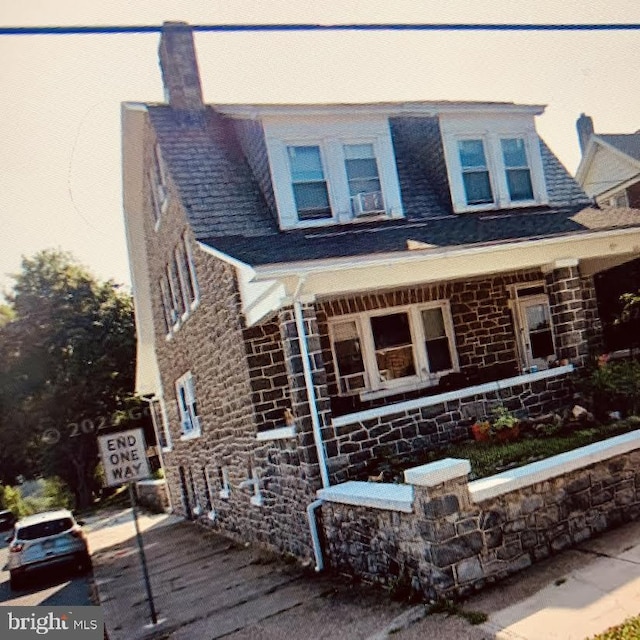 view of front facade featuring stone siding and brick siding