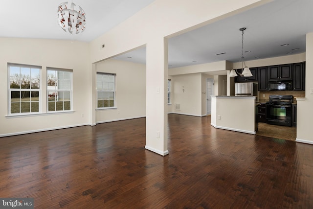 unfurnished living room featuring wood finished floors and baseboards