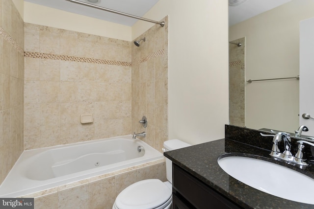 bathroom with bathing tub / shower combination, toilet, and vanity