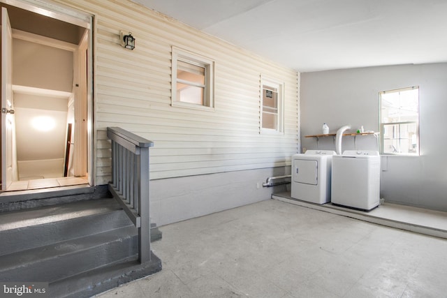 laundry room featuring washing machine and clothes dryer and tile patterned floors