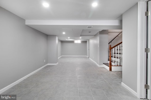 finished below grade area with stairs, recessed lighting, visible vents, and baseboards