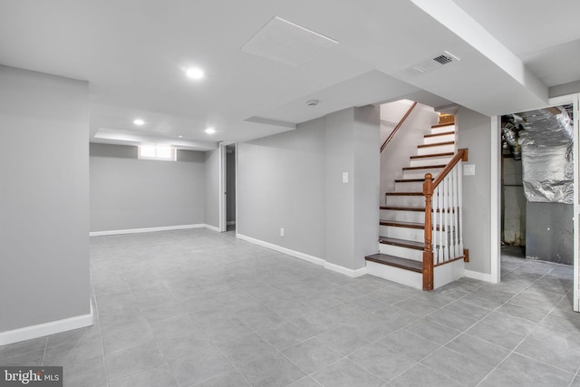 below grade area featuring stairway, baseboards, visible vents, and recessed lighting