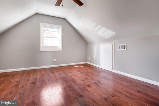 additional living space with lofted ceiling, hardwood / wood-style flooring, baseboards, and visible vents