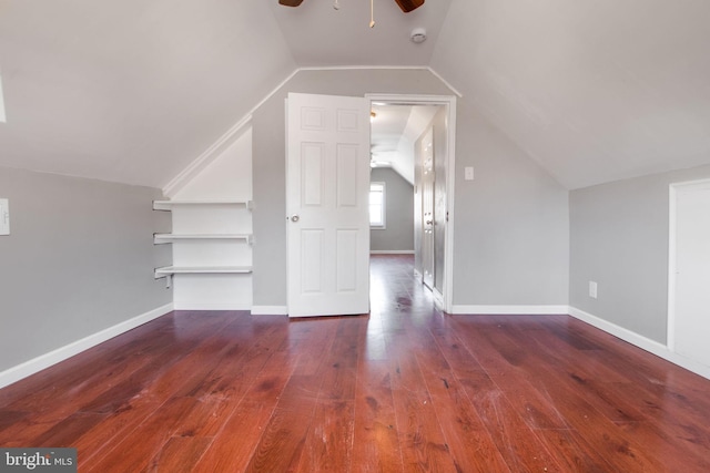 additional living space featuring vaulted ceiling, ceiling fan, hardwood / wood-style floors, and baseboards