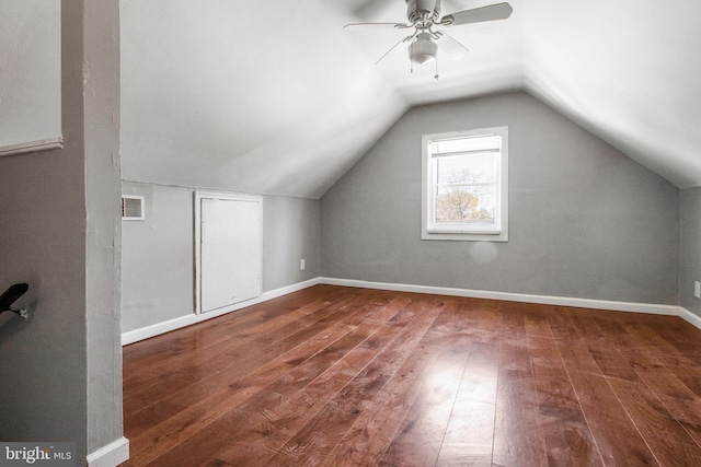 bonus room with lofted ceiling, hardwood / wood-style flooring, baseboards, and visible vents