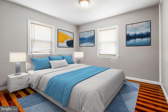 bedroom with baseboards and wood finished floors