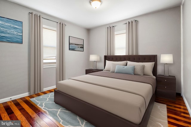 bedroom with wood finished floors and baseboards