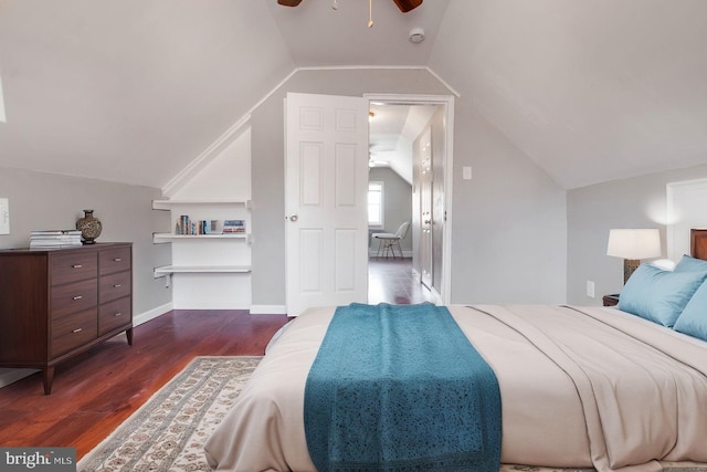 bedroom with lofted ceiling, dark wood-type flooring, a ceiling fan, and baseboards