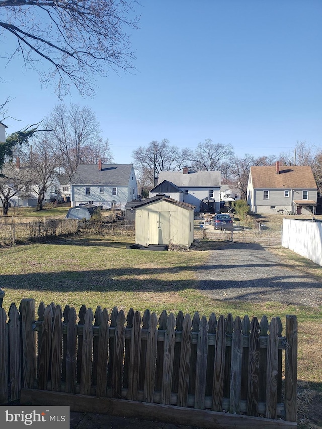 6114 Belwood St, District Heights, MD 20747 - view of yard featuring a residential view, an outbuilding, a storage shed, and fence private yard