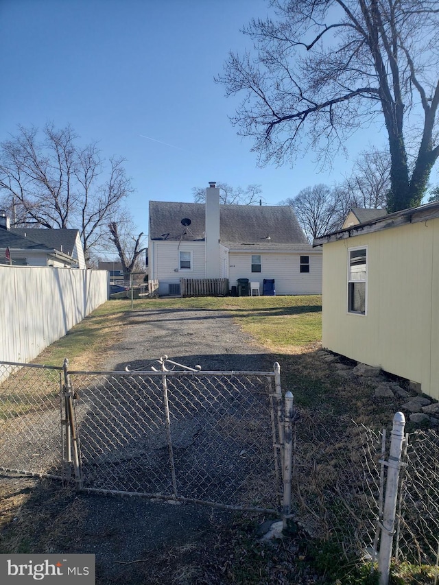 6114 Belwood St, District Heights, MD 20747 - view of yard with aphalt driveway, a gate, and fence private yard
