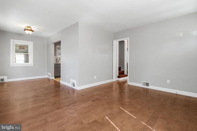 unfurnished room featuring visible vents and baseboards