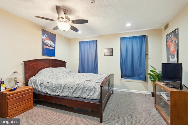 carpeted bedroom with a ceiling fan, baseboards, visible vents, and a textured ceiling