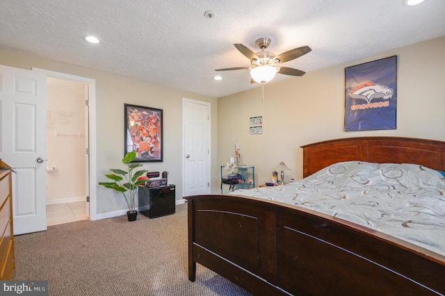 bedroom featuring a textured ceiling, recessed lighting, baseboards, and light carpet