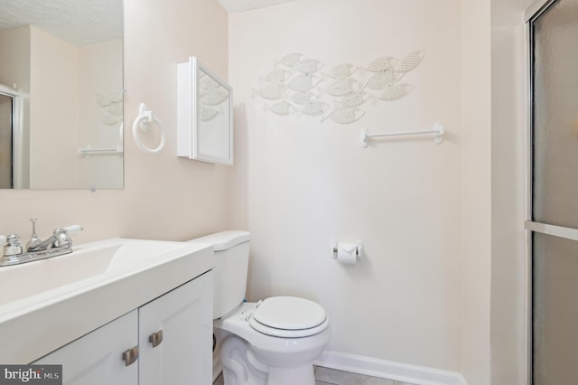 bathroom with a shower with door, toilet, and vanity