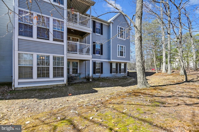 back of property featuring a balcony