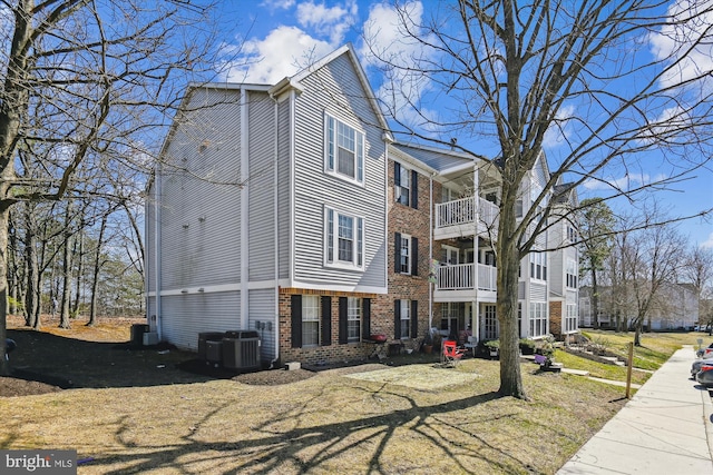 view of front of house featuring brick siding and central AC unit