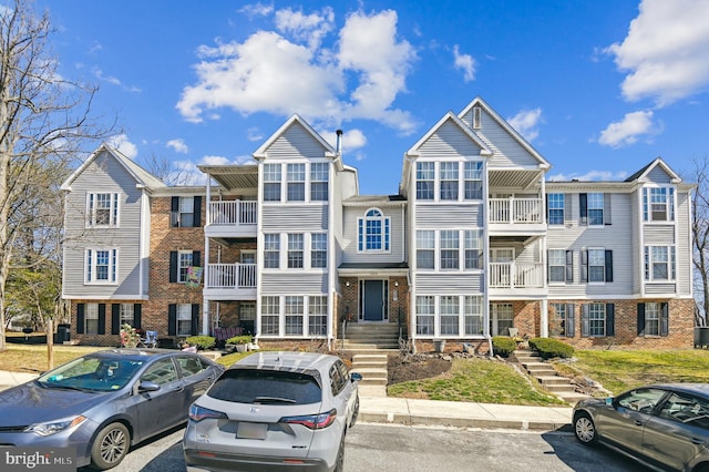 townhome / multi-family property featuring brick siding