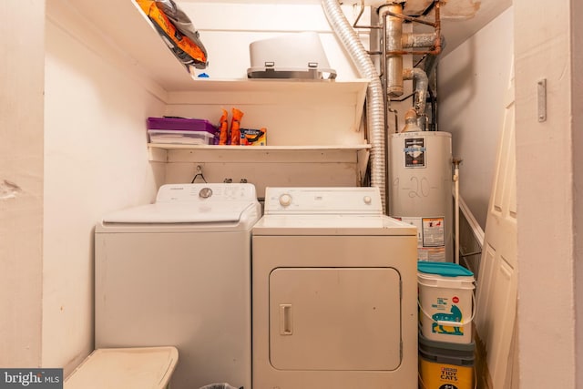 laundry area with laundry area, washer and clothes dryer, and gas water heater