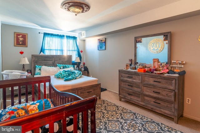 bedroom featuring baseboards and light colored carpet