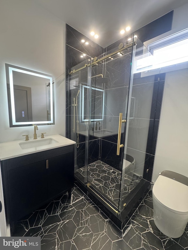 full bathroom featuring toilet, a shower stall, and vanity