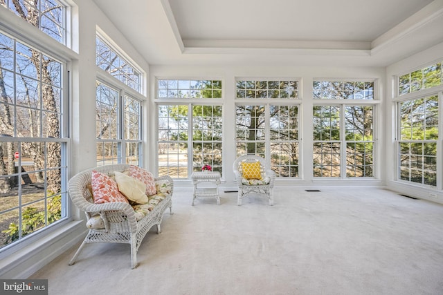 sunroom with visible vents and a raised ceiling