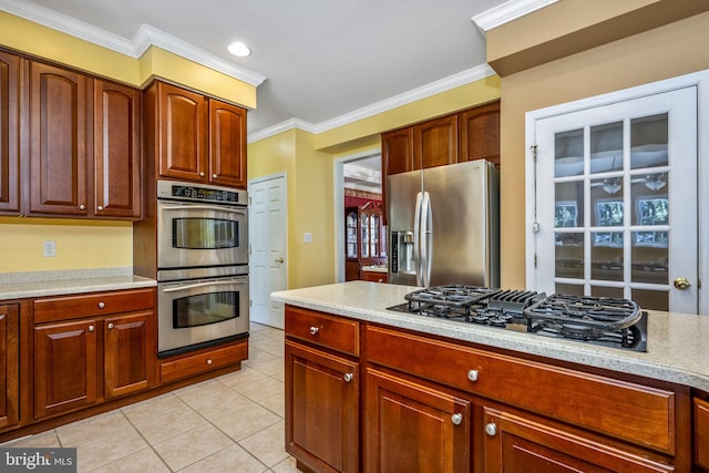 kitchen with appliances with stainless steel finishes, light countertops, and crown molding