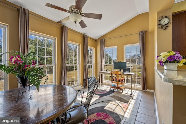 sunroom featuring plenty of natural light, a ceiling fan, and vaulted ceiling