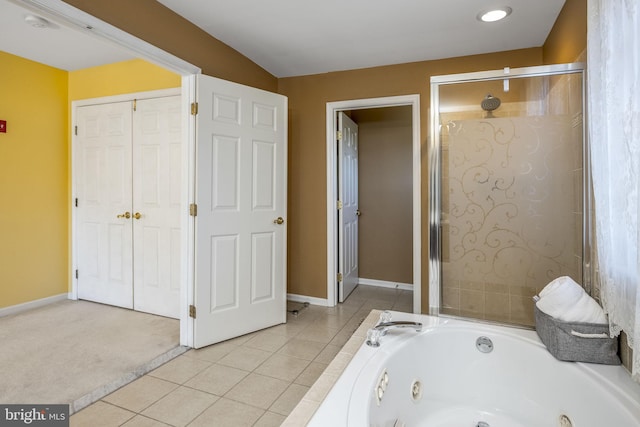 full bath featuring tile patterned floors, a tub with jets, baseboards, and a shower with door