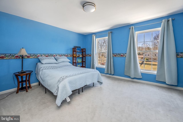 carpeted bedroom with baseboards