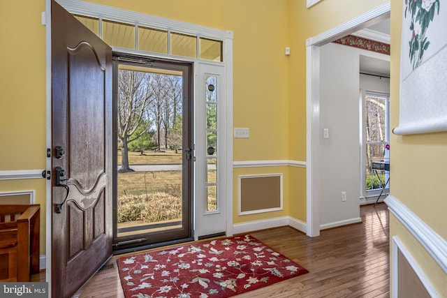 entrance foyer with baseboards and wood finished floors