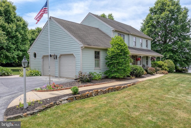 view of front of home with aphalt driveway, an attached garage, a front lawn, and a shingled roof