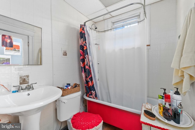 full bathroom featuring toilet, tile walls, and shower / bath combination with curtain