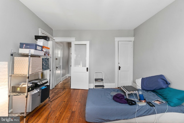 bedroom featuring wood finished floors and baseboards